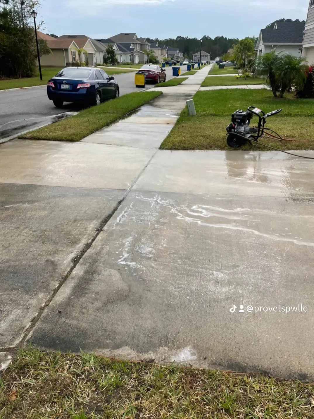 Pro Vets Pressure Washing equipment mid-job cleaning a neighborhood sidewalk and driveway in St. Johns, Florida